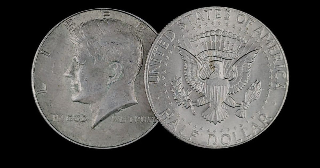 Front and back of a Kennedy half dollar on a black background
