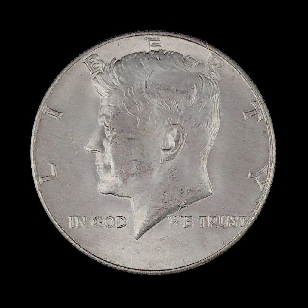 Silver coin with a profile of a person and 'In God We Trust' inscription on a black background