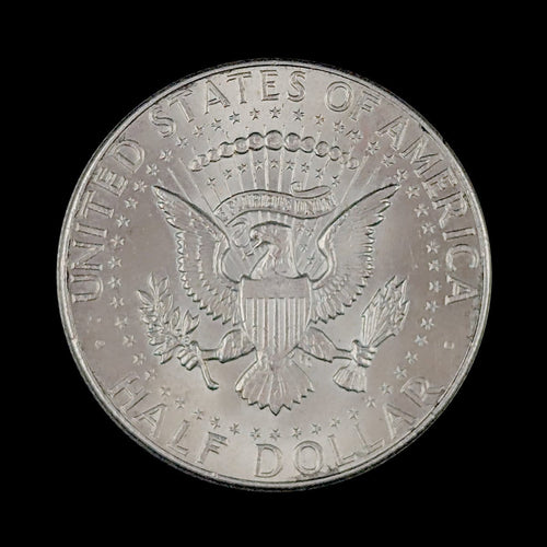 Silver half dollar coin with an eagle on a black background