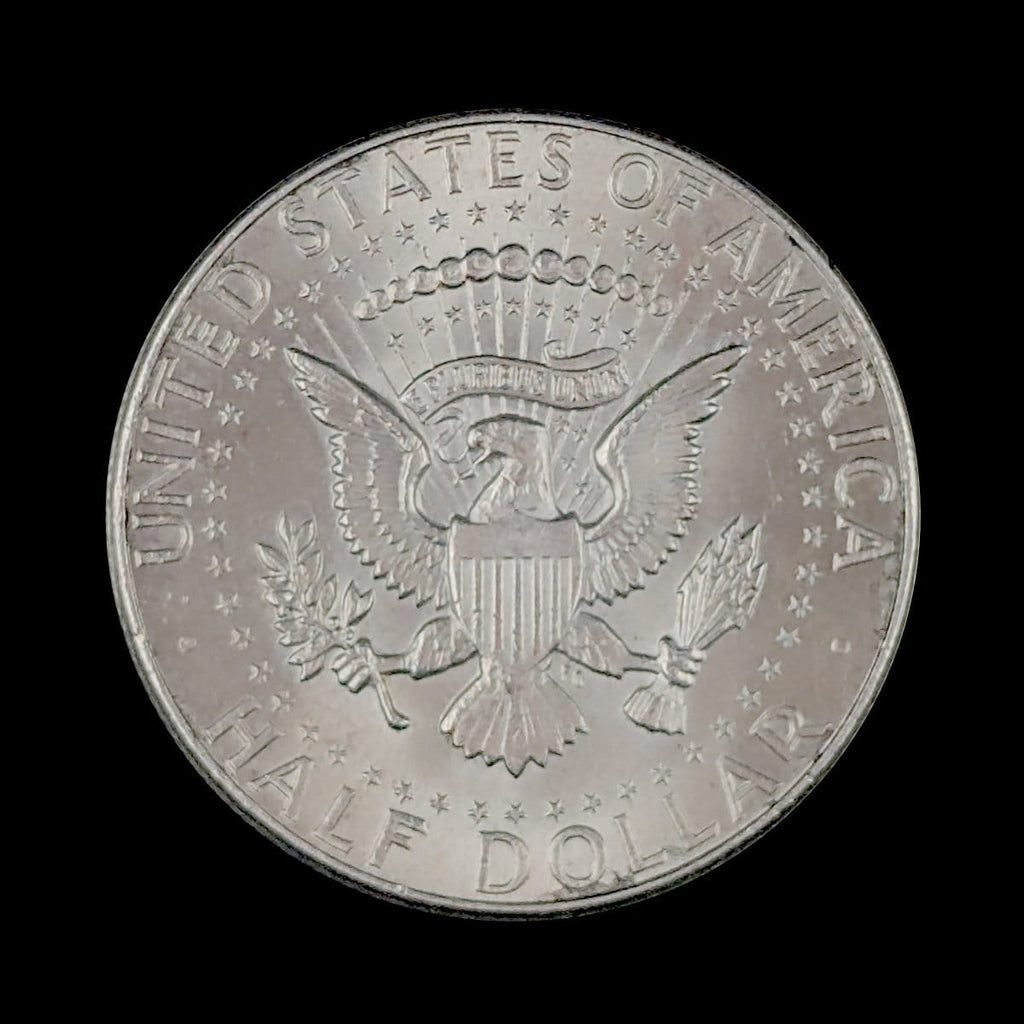 Silver half dollar coin with eagle on a black background