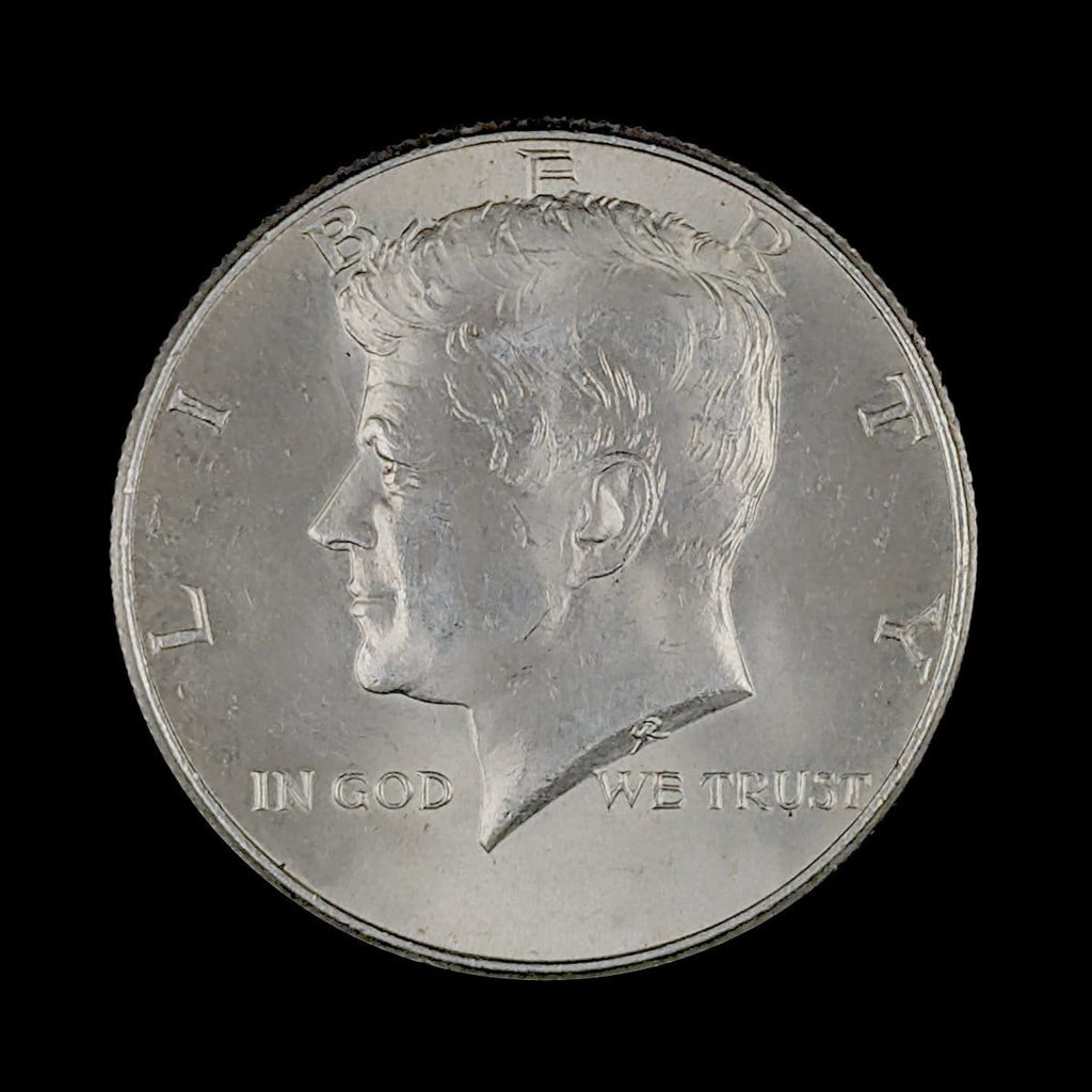 Obverse of a circulated Kennedy Half Dollar silver coin featuring President John F. Kennedy