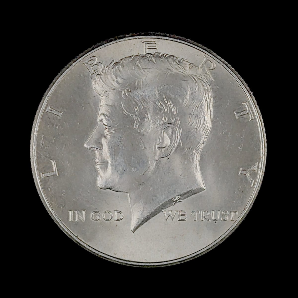 Obverse of a circulated Kennedy Half Dollar silver coin featuring President John F. Kennedy
