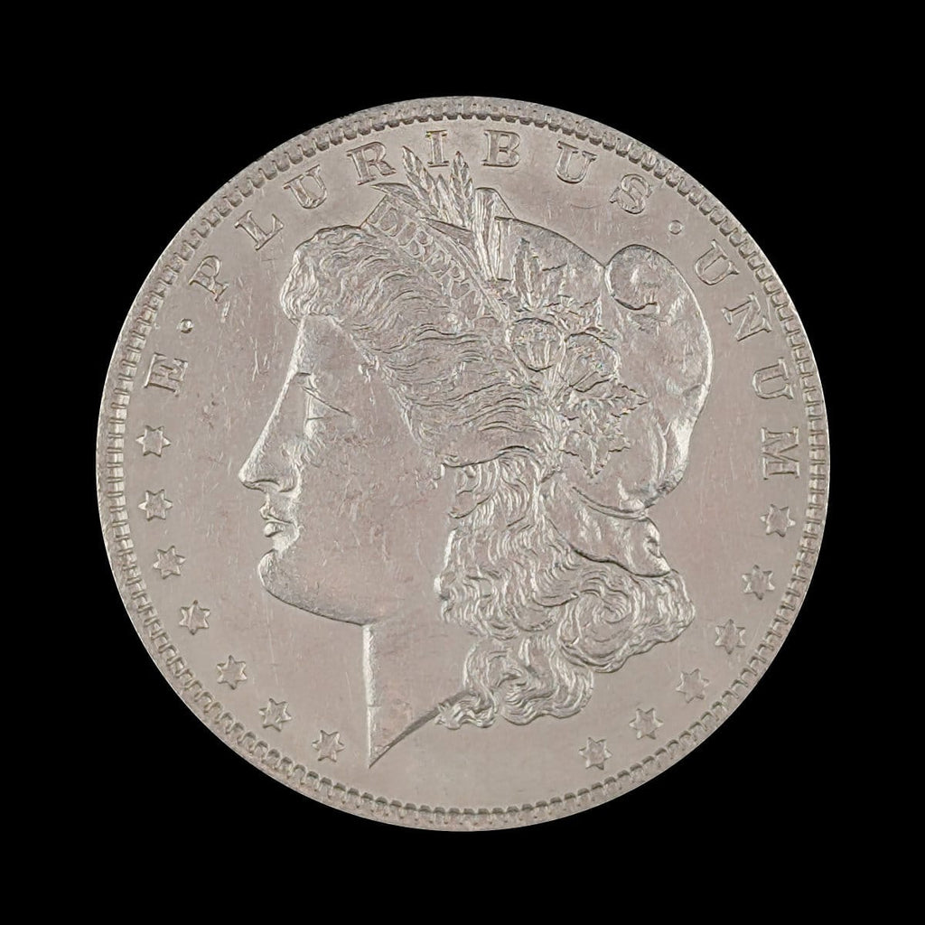 Silver coin with a profile of a person and star design on a black background